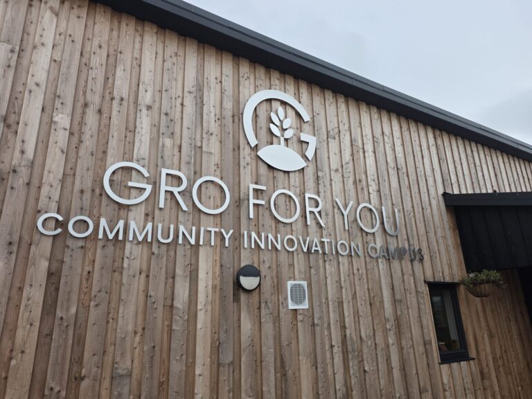 Gro For You Community Innovation Campus sign on the timber wall of the new building in Tain